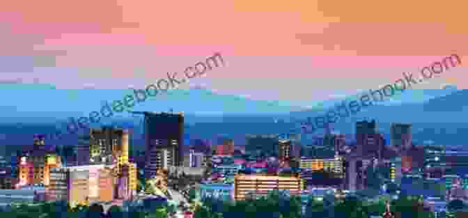 A Panoramic View Of Asheville, North Carolina, Showcasing The Vibrant Cityscape Nestled Amidst The Majestic Blue Ridge Mountains. Southern Escapades: On The Roads Less Travelled